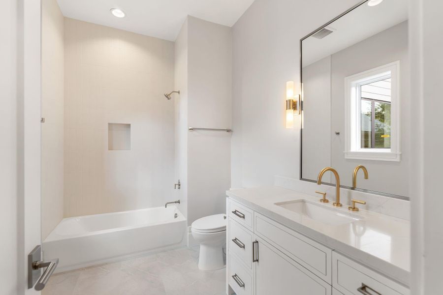 Guest bathroom with tub/shower combo.