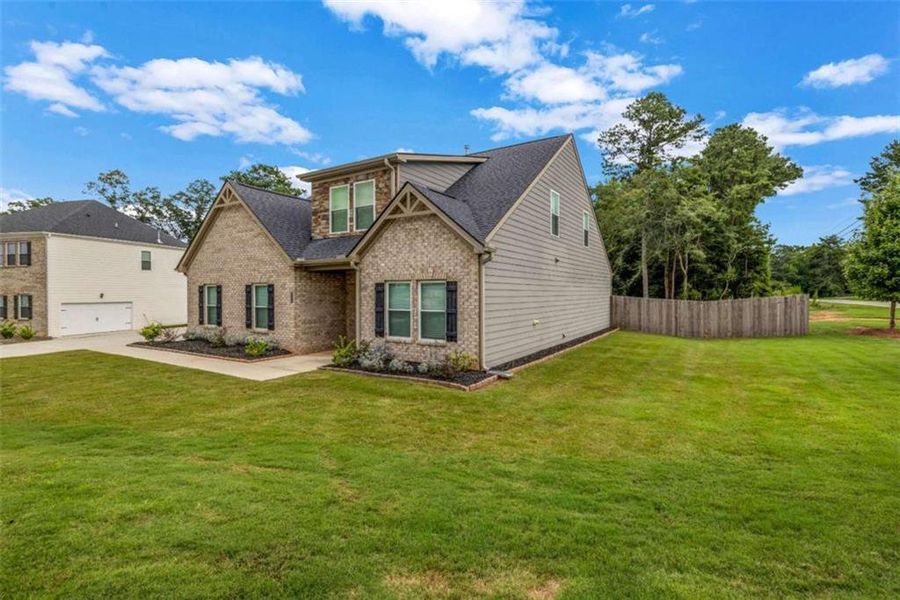 Front exterior of a new home in Palmetto Oaks Phase III, Palmetto, GA, highlighting curb appeal (Image 23). Front exterior of a new home in Palmetto Oaks Phase III, Palmetto, GA, highlighting curb appeal (Image 23).
