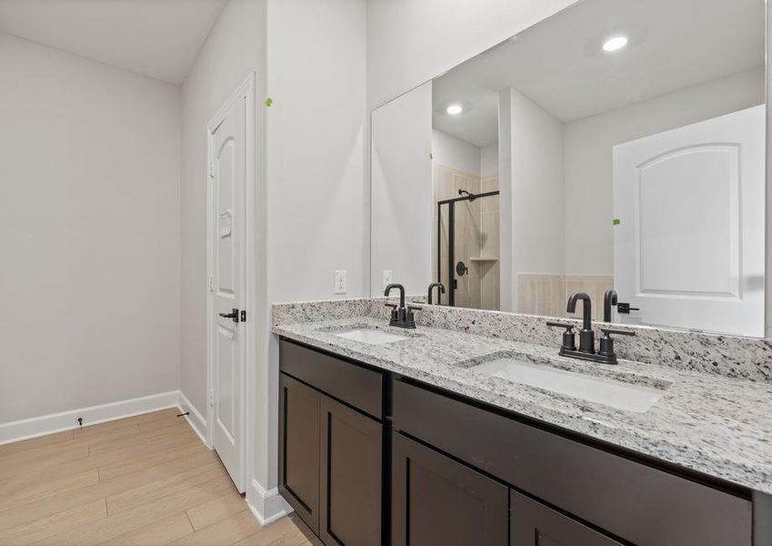 The master bathroom has dual sinks and plenty of vanity space.