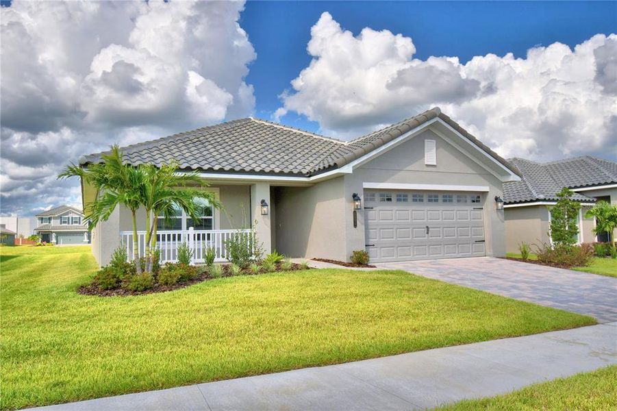 Front exterior of a new home in , Auburndale, FL, highlighting curb appeal (Image 1). Front exterior of a new home in , Auburndale, FL, highlighting curb appeal (Image 1).