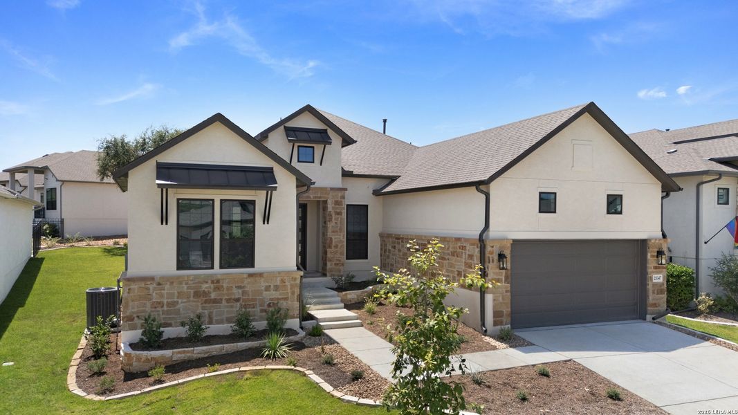 Front exterior of a new home in El Sonido at Campanas, San Antonio, TX, highlighting curb appeal (Image 19).