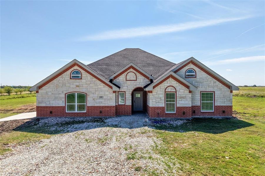 French provincial home featuring stone & brick siding