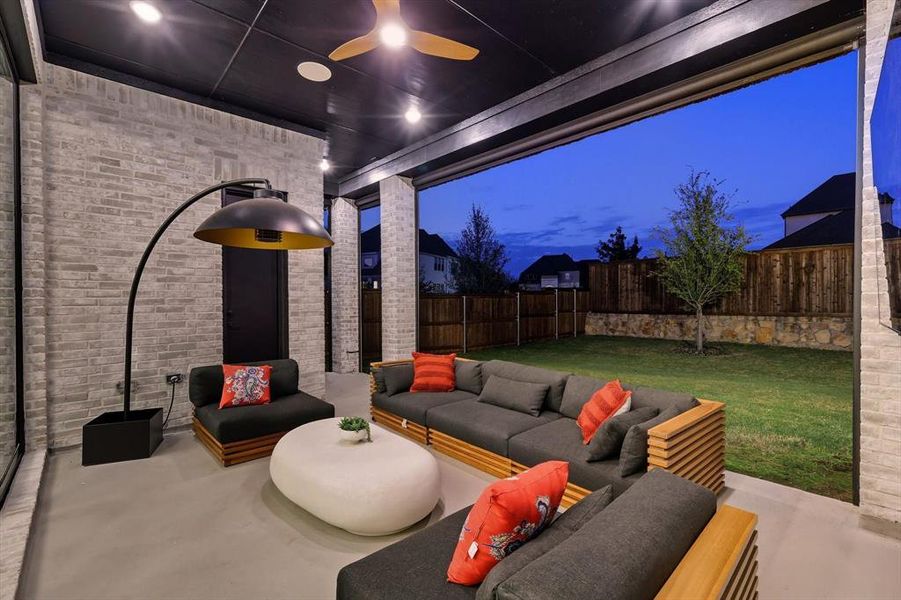 Enjoy the fenced backyard on those cool evenings. Featuring a patio area, an outdoor living space, and a ceiling fan Enjoy the fenced backyard on those cool evenings. Featuring a patio area, an outdoor living space, and a ceiling fan