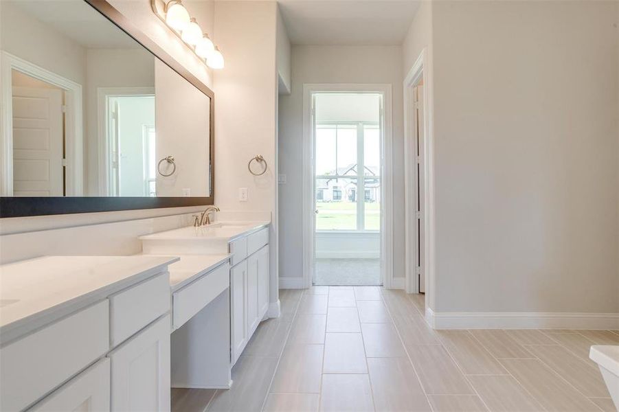 Bathroom with tile patterned flooring and vanity