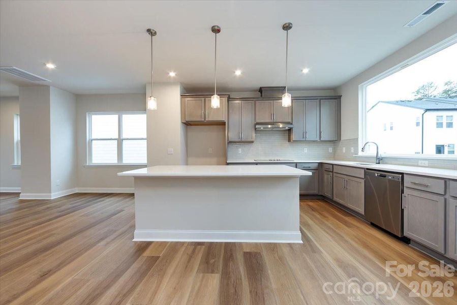 Gourmet Kitchen with Grey Cabinets and White Quartz Countertops