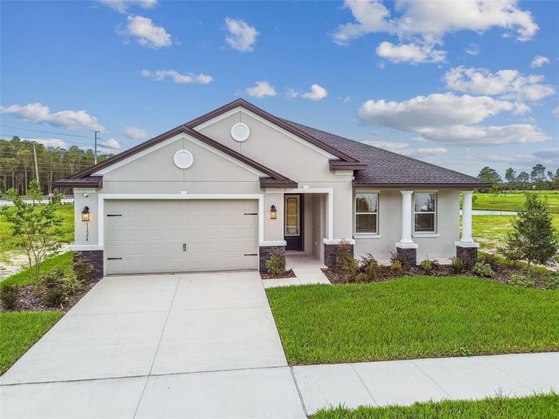 Front exterior of a new home in Hidden Ridge, New Port Richey, FL, highlighting curb appeal (Image 27). Front exterior of a new home in Hidden Ridge, New Port Richey, FL, highlighting curb appeal (Image 27).
