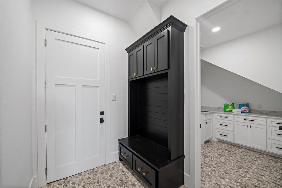 Stylish mudroom featuring sleek cabinetry and practical storage solutions, perfect for organizing outdoor gear and maintaining a tidy home entrance.