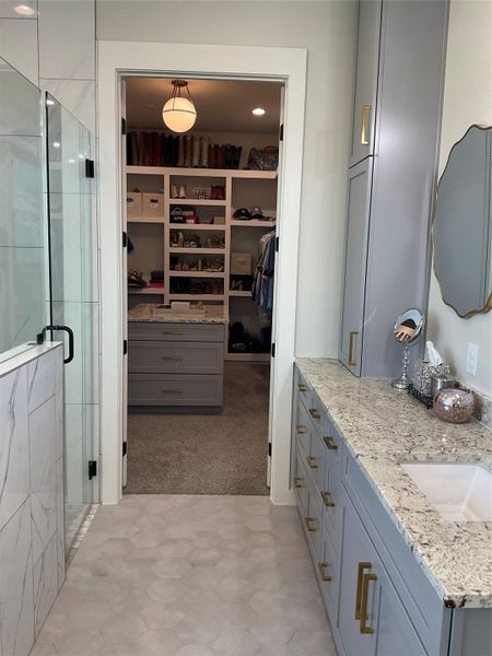 Primary bath looking into custom walk in closet