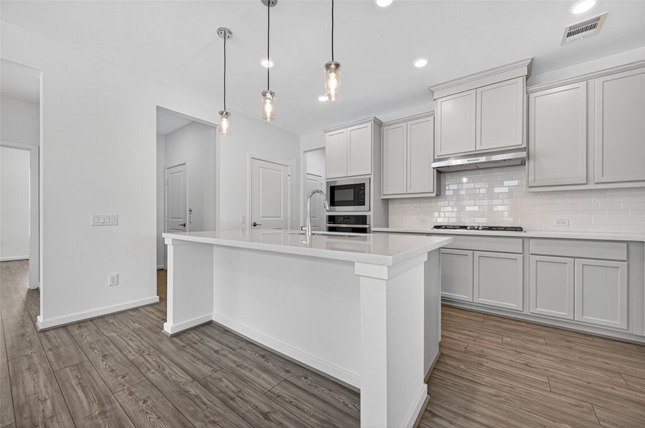 This kitchen features an abundance of sleek cabinetry, offering ample storage space to keep everything organized and within easy reach.