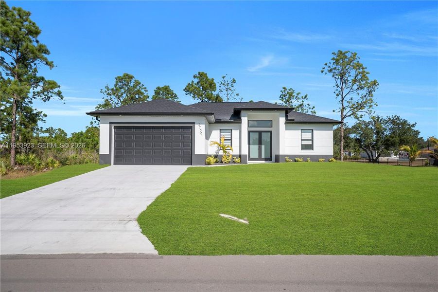 Front exterior of a new home in , Lehigh Acres, FL, highlighting curb appeal (Image 24).