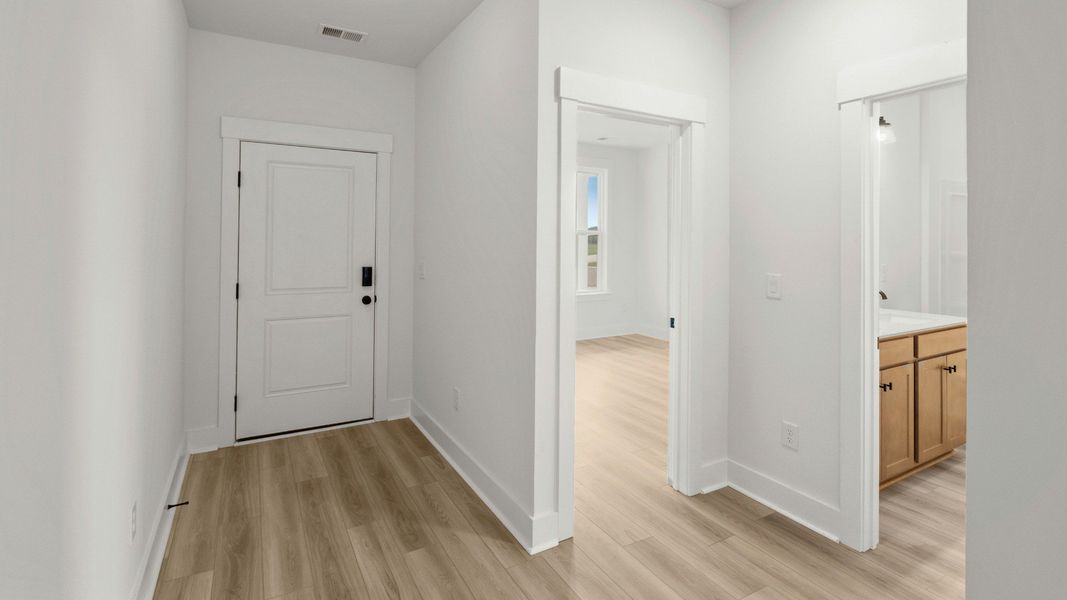 Hallway connecting two secondary bedrooms at Chestnut Farms by DRB Homes