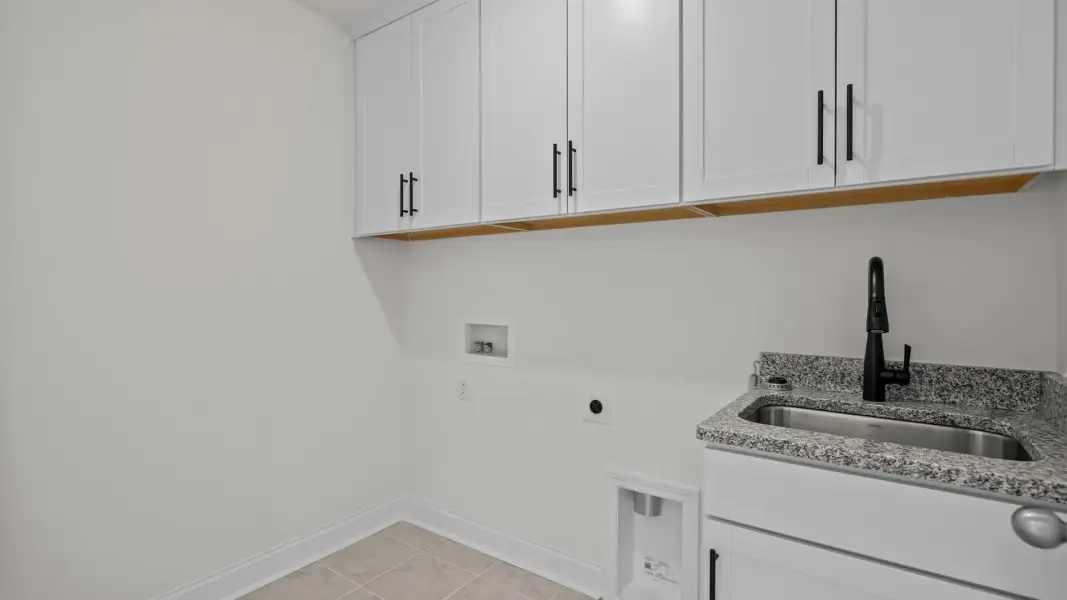 Conveniently located laundry room with sink and premium cabinets, in the Norris Design by DRB Homes in York, SC Conveniently located laundry room with sink and premium cabinets, in the Norris Design by DRB Homes in York, SC