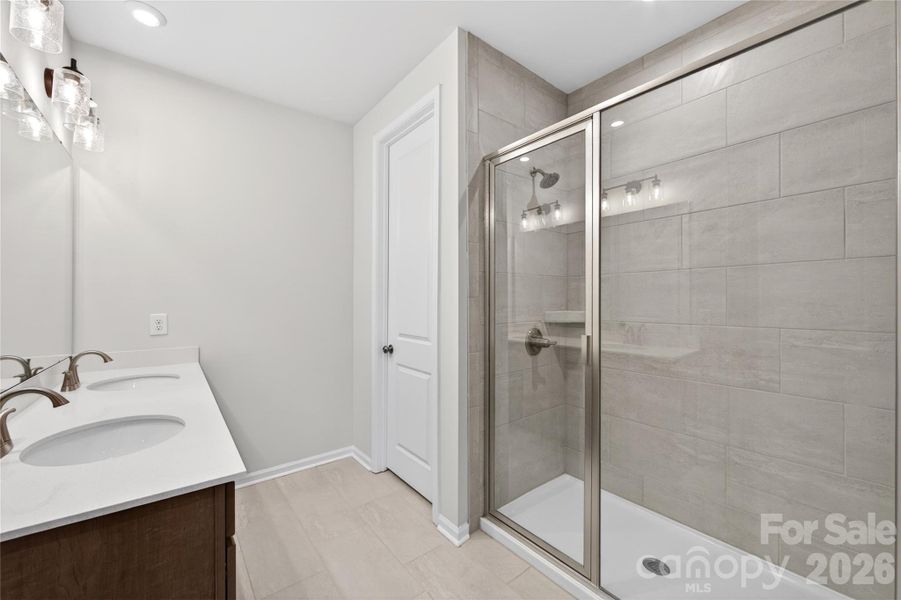 Dual vanity primary bathroom with a walk-in shower Dual vanity primary bathroom with a walk-in shower