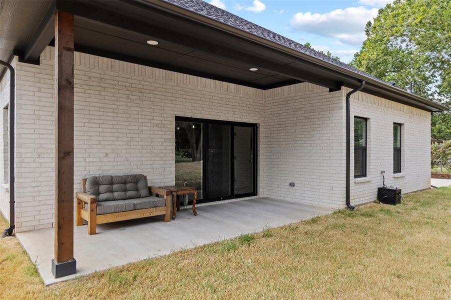 Covered patio featuring a concrete slab and a stained wood support post