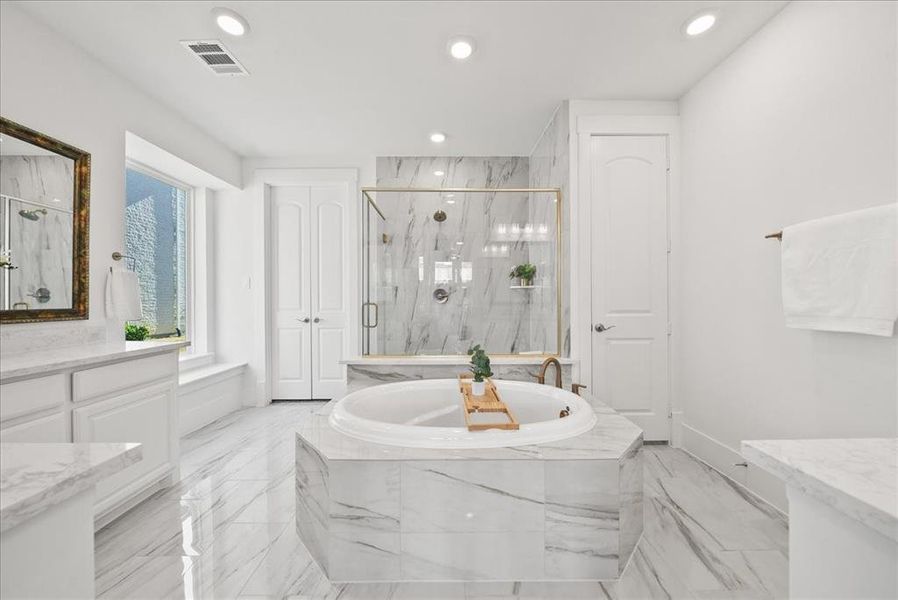 Full bath featuring a marble finish shower, a garden tub, light marble finish floors, vanity, and recessed lighting Full bath featuring a marble finish shower, a garden tub, light marble finish floors, vanity, and recessed lighting