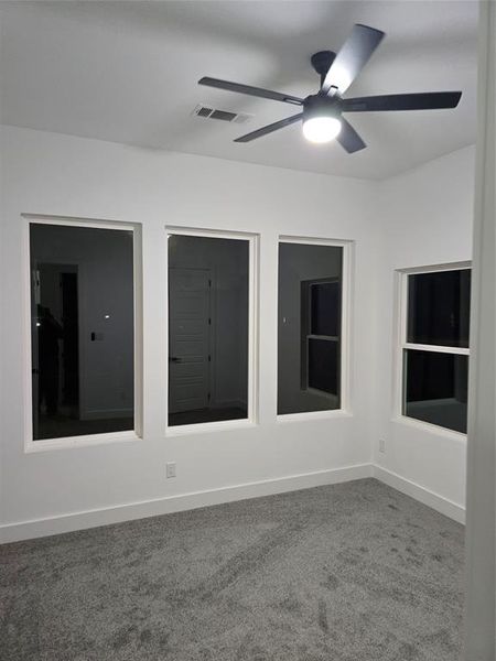 Empty room with ceiling fan and carpet