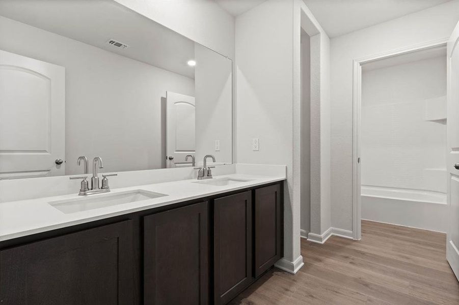 Bathroom with wood-type flooring and double vanity