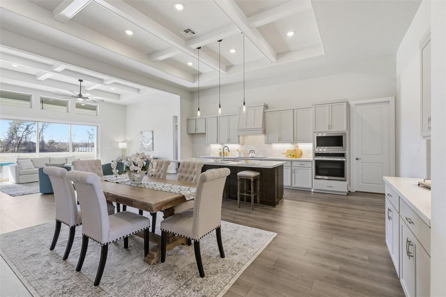 Dining room featuring coffered ceiling, a ceiling fan, light wood-type flooring, and recessed lighting