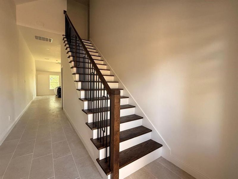 Stairs with tile patterned flooring and baseboards Stairs with tile patterned flooring and baseboards