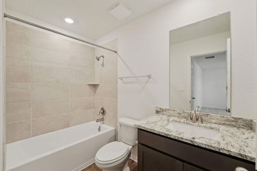 Bathroom featuring shower / bathtub combination, vanity, and recessed lighting