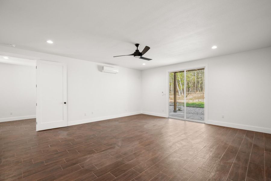 Spare room with recessed lighting, dark wood-type flooring, and a ceiling fan