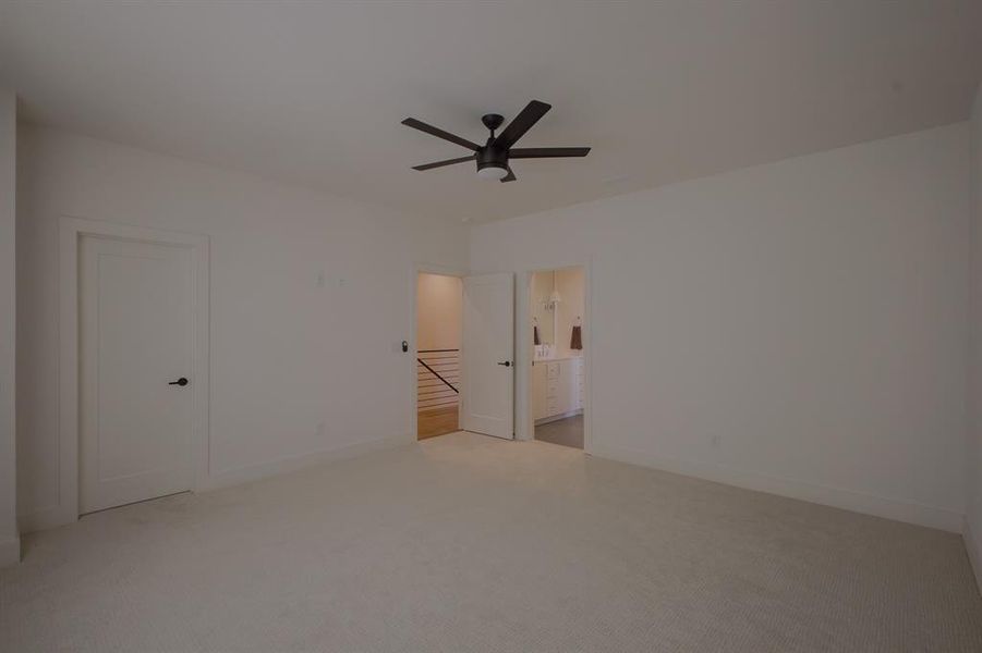 Unfurnished room with ceiling fan and light carpet