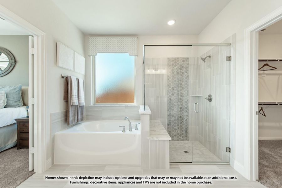 Master bathroom with soaking tub, glass-enclosed shower, tile accents, and walk-in closet access