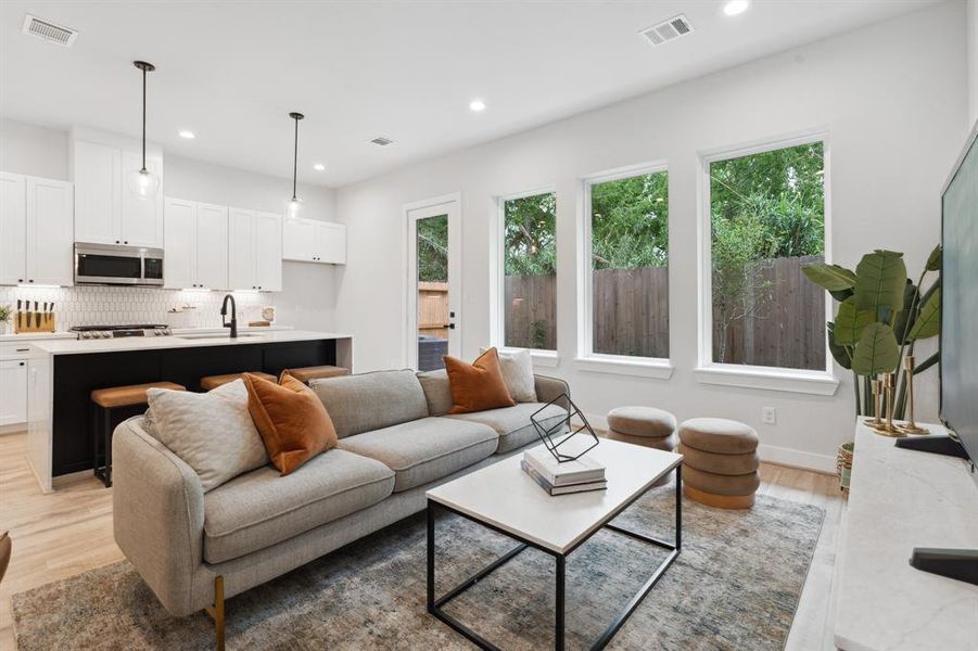 The kitchen's open design overlooking the living room establishes a perfect stage for entertaining.