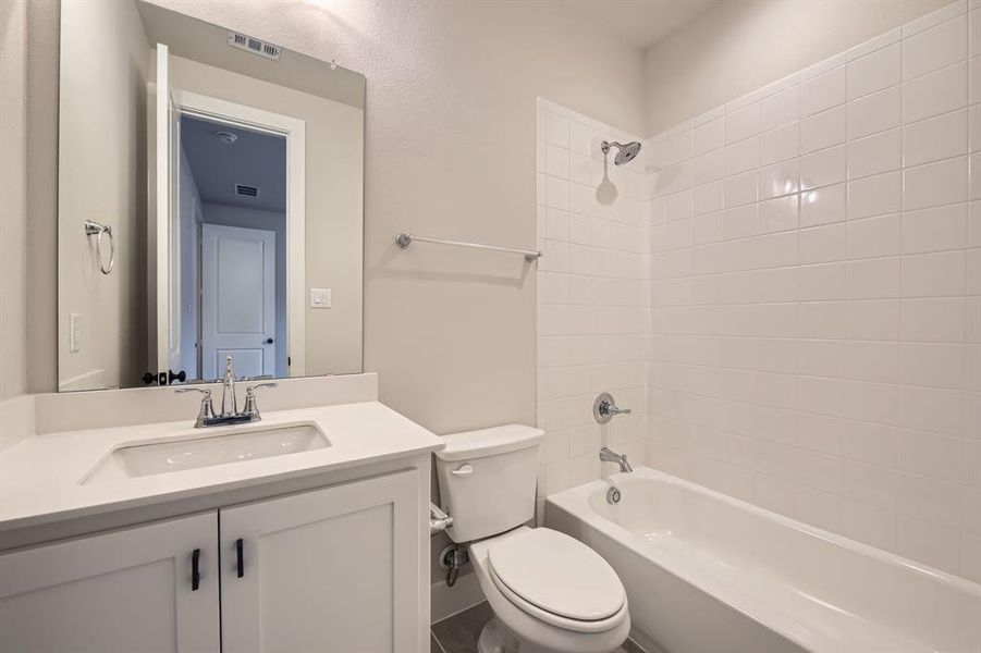 Full bathroom featuring vanity and shower combination Full bathroom featuring vanity and shower combination