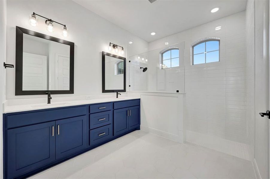 Bathroom with a walk in shower, double vanity, and light tile patterned floors Bathroom with a walk in shower, double vanity, and light tile patterned floors