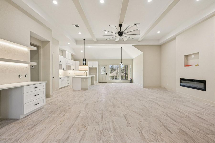 From the moment you enter, warm wood finishes create an elegant feel, complemented by high ceilings and an open-concept layout that flows seamlessly into the kitchen.