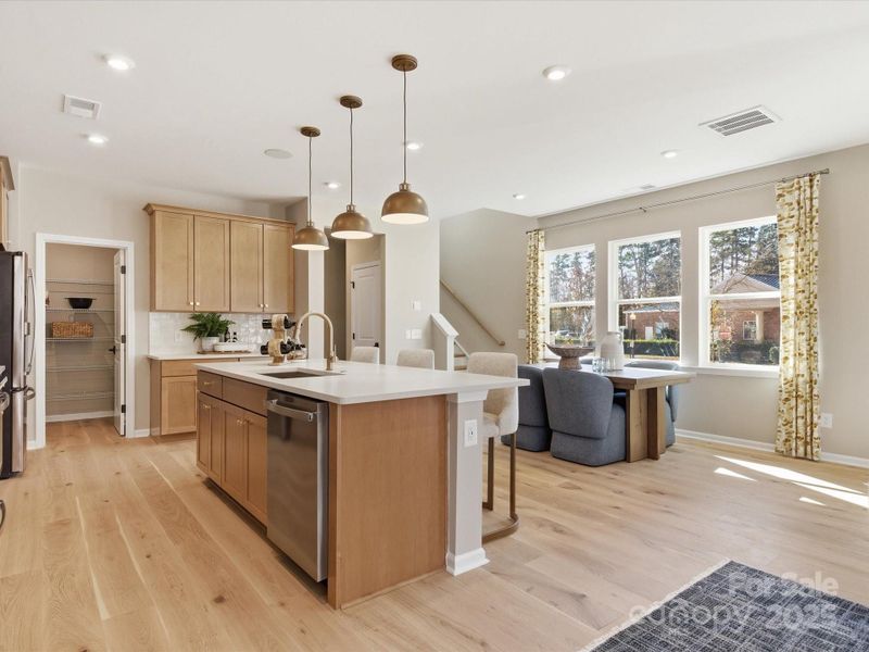 Large Central Island Ideal for Entertaining. *Model Photos | Actual Finishes, Structural Selections, and Orientation May Vary.