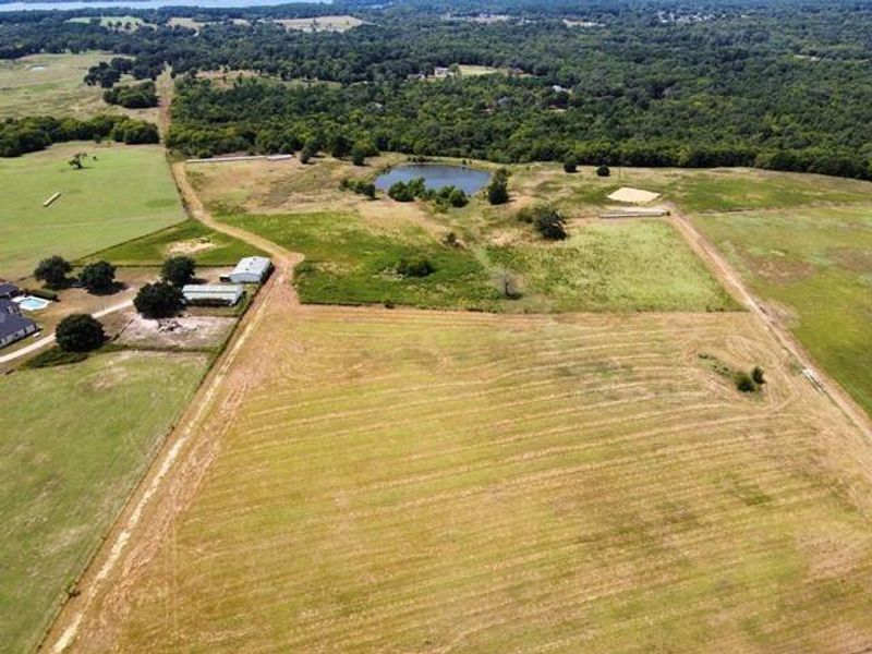 Aerial view of sparsely populated area with farmland and a nearby body of water Aerial view of sparsely populated area with farmland and a nearby body of water