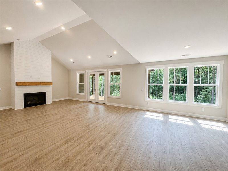 A spacious living area with soaring ceilings and a