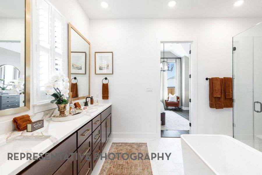 Full bathroom featuring ensuite bath, double vanity, a freestanding tub, recessed lighting, and a shower with shower door