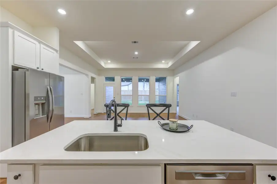 Discover the perfect blend of elegance and functionality in this kitchen, featuring a stunning granite island that seamlessly connects to a spacious, light-filled living area. Discover the perfect blend of elegance and functionality in this kitchen, featuring a stunning granite island that seamlessly connects to a spacious, light-filled living area.
