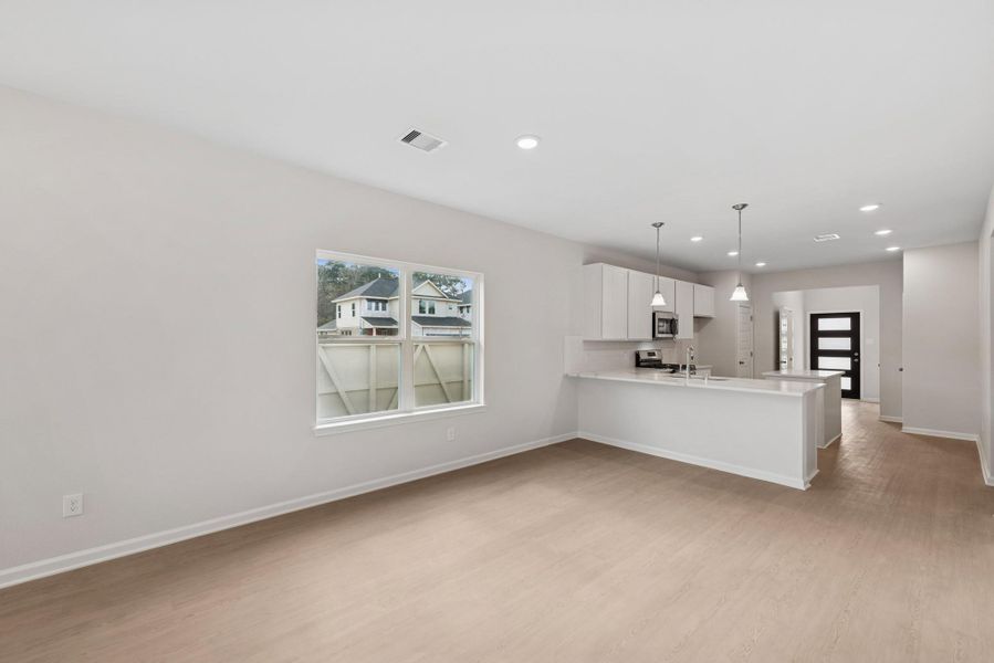 The Cardinal II- Family Room into Dining Area. Photos of home shown are for illustration only; actual features, colors, and upgrades may vary.