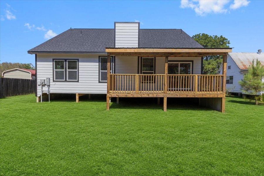 Virtual grass: A wooden deck extends from the rear of the home into the backyard. Virtual grass: A wooden deck extends from the rear of the home into the backyard.