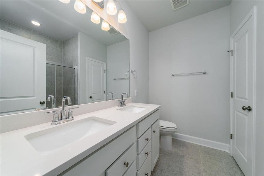 Owner's Bathroom showcases a dual-sink vanity and a shower. Owner's Bathroom showcases a dual-sink vanity and a shower.