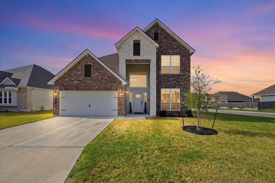 Traditional-style home with covered entryway, brick, stone, and Hardie siding, and a 2-car garage Traditional-style home with covered entryway, brick, stone, and Hardie siding, and a 2-car garage