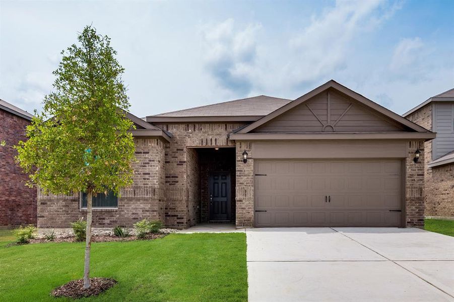 View of front of property with a garage and a front lawn