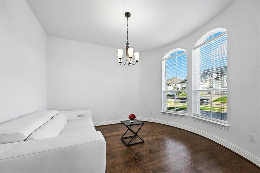 Living area featuring a chandelier and wood finished floors