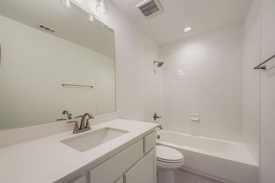 Bathroom featuring shower / tub combination, vanity, recessed lighting, and tile patterned flooring