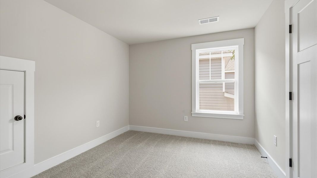 Bright and serene bedroom with comfortable carpeted flooring and large windows for vibrant light Bright and serene bedroom with comfortable carpeted flooring and large windows for vibrant light