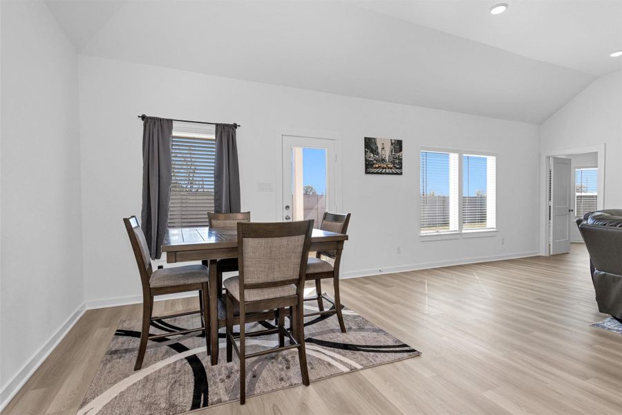 Bright, open dining area with natural light, flowing seamlessly into the kitchen and family room for easy entertaining.