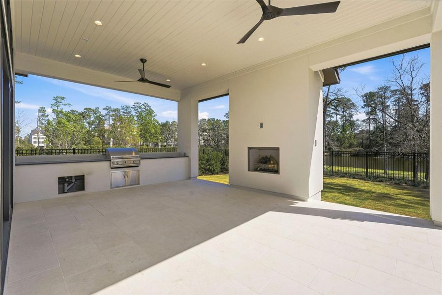 This expansive first-floor outdoor patio, complete with a summer kitchen and gas fireplace commands sweeping, unobstructed water views. Exceptional setting for year-round entertaining. This expansive first-floor outdoor patio, complete with a summer kitchen and gas fireplace commands sweeping, unobstructed water views. Exceptional setting for year-round entertaining.