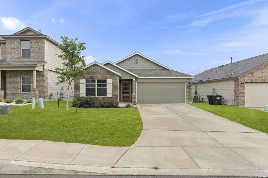 Front exterior of a new home in Hunters Ranch, San Antonio, TX, highlighting curb appeal (Image 2). Front exterior of a new home in Hunters Ranch, San Antonio, TX, highlighting curb appeal (Image 2).