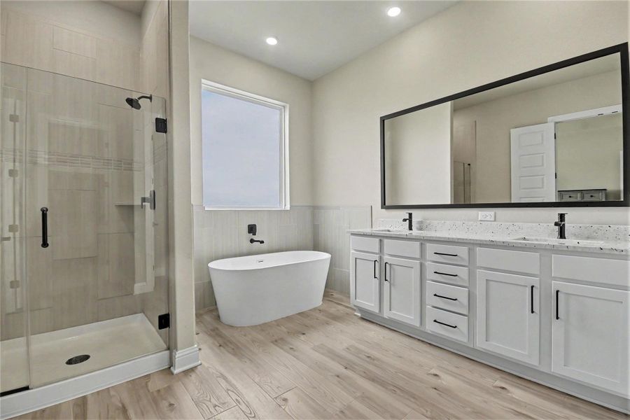 This modern bathroom features a spacious glass-enclosed shower, a sleek freestanding tub, and a double vanity with ample storage and a large mirror. The light wood flooring and neutral walls create a bright, airy ambiance. This modern bathroom features a spacious glass-enclosed shower, a sleek freestanding tub, and a double vanity with ample storage and a large mirror. The light wood flooring and neutral walls create a bright, airy ambiance.