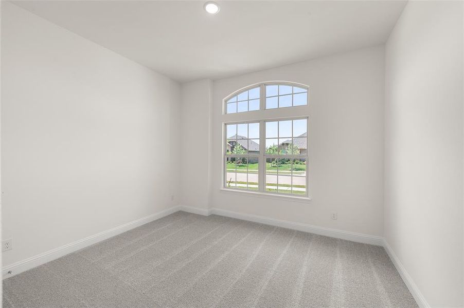 Spare room with light colored carpet and recessed lighting