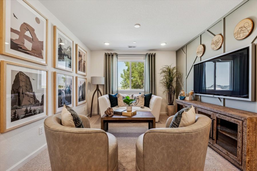 A living room with a tv and couches. A living room with a tv and couches.
